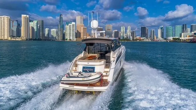 Presumed Innocent Yacht Photos Pics 2017 Princess V48 Open yacht cruising near city skyline.