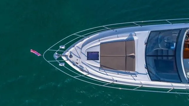 Presumed Innocent Yacht Photos Pics Aerial view of 2017 Princess V48 Open yacht on clear blue water.