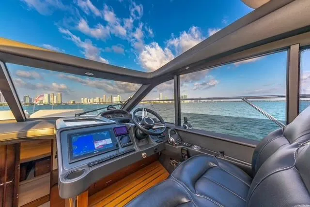 Presumed Innocent Yacht Photos Pics Interior view of 2017 Princess V48 Open yacht with city skyline and ocean.