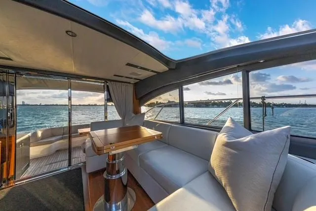 Presumed Innocent Yacht Photos Pics Luxurious interior of 2017 Princess V48 Open yacht with ocean view.