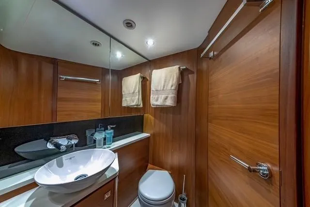 Presumed Innocent Yacht Photos Pics Luxurious bathroom in 2017 Princess V48 Open yacht with modern fixtures and wooden accents.
