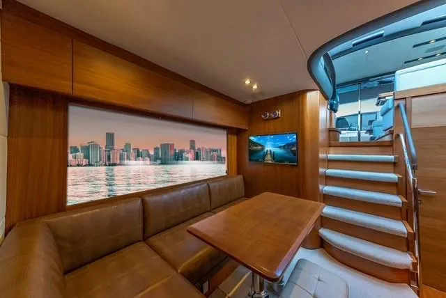 Presumed Innocent Yacht Photos Pics Luxurious interior of 2017 Princess V48 Open yacht with city skyline view.