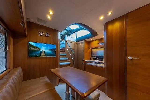 Presumed Innocent Yacht Photos Pics Interior of 2017 Princess V48 Open yacht with modern design and wooden finishes.