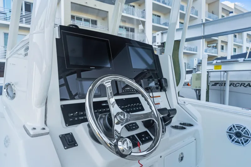  Yacht Photos Pics 2023 Cobia 301 Center Console boat dashboard with steering wheel and navigation screens.
