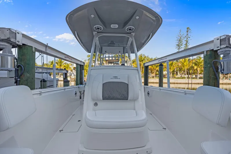  Yacht Photos Pics 2023 Cobia 301 Center Console boat docked, showcasing sleek design and spacious seating.