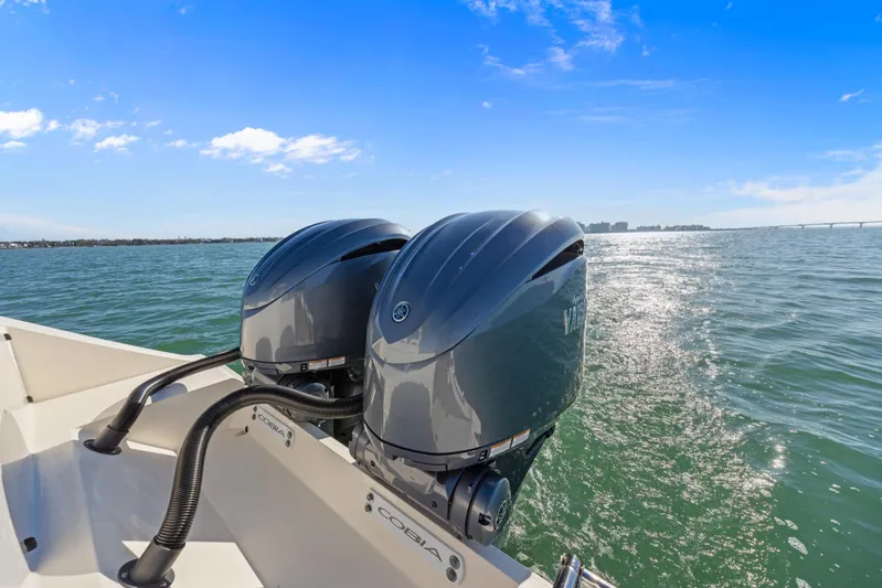  Yacht Photos Pics 2023 Cobia 301 Center Console with dual outboard engines on open water.
