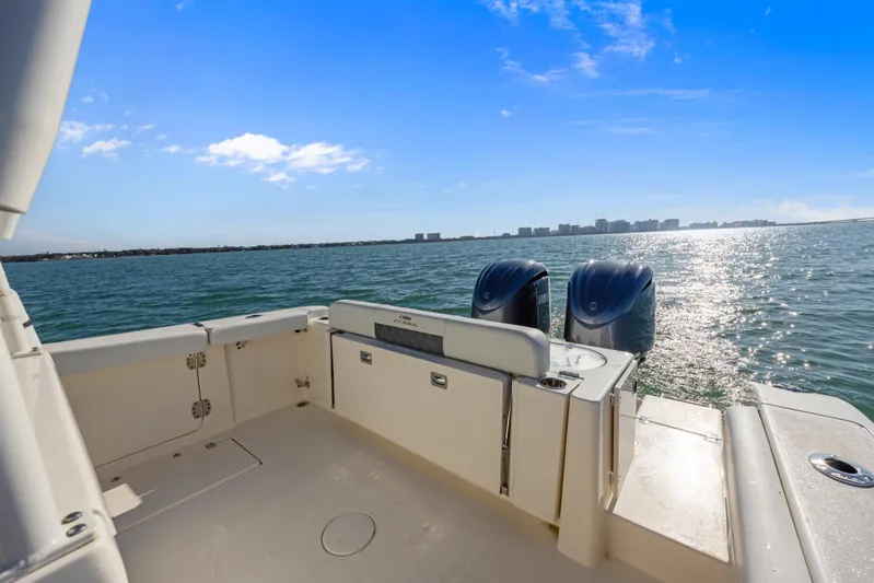  Yacht Photos Pics 2023 Cobia 301 Center Console boat on open water, sunny day, dual engines.