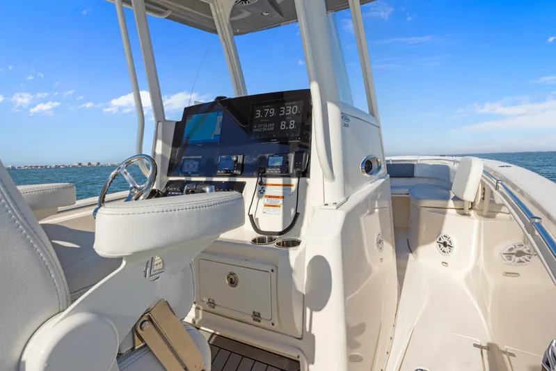  Yacht Photos Pics 2023 Cobia 301 Center Console boat interior with modern dashboard and ocean view.