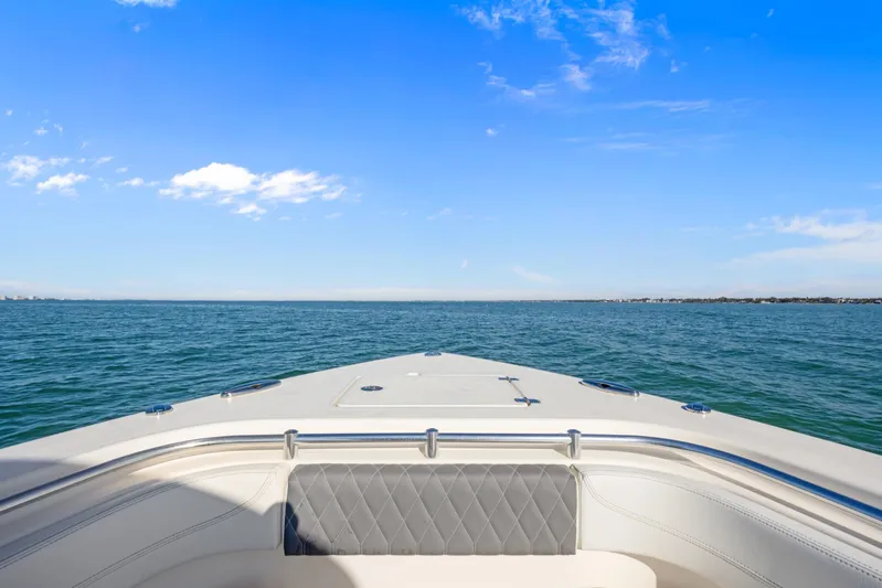  Yacht Photos Pics 2023 Cobia 301 Center Console boat on open water under clear blue sky.