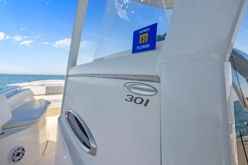  Yacht Photos Pics 2023 Cobia 301 Center Console boat on open water, Florida registration visible.