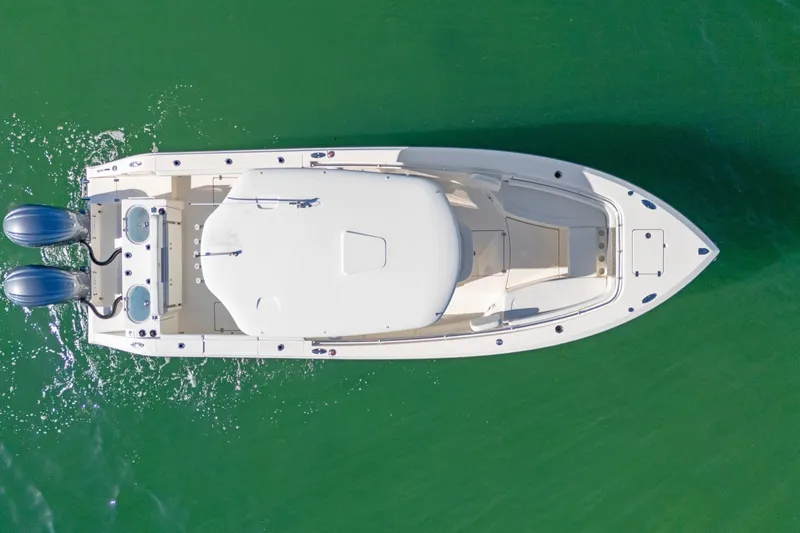  Yacht Photos Pics Overhead view of 2023 Cobia 301 Center Console boat on green water.