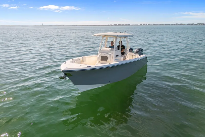  Yacht Photos Pics 2023 Cobia 301 Center Console boat on calm ocean waters under clear blue sky.