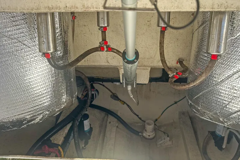  Yacht Photos Pics 2023 Cobia 301 Center Console boat engine compartment with insulated components and hoses.