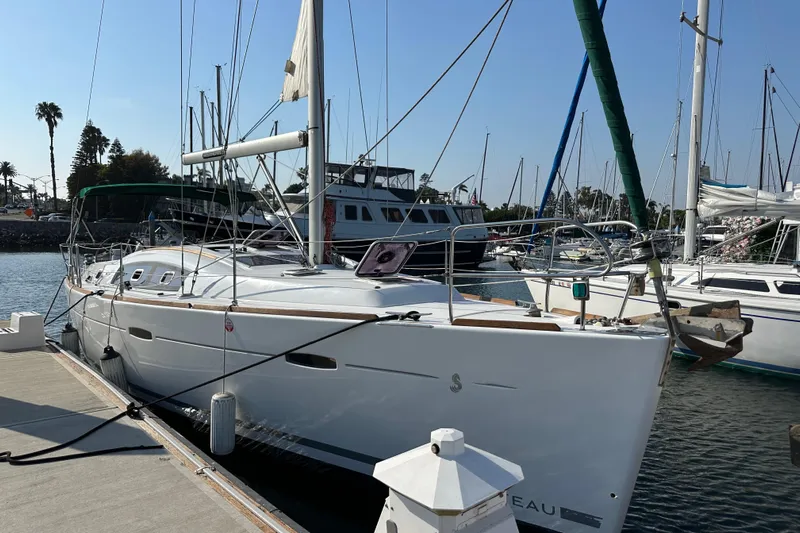 Shamrock Yacht Photos Pics 2011 Beneteau Oceanis 40 sailboat docked at marina under clear blue sky.