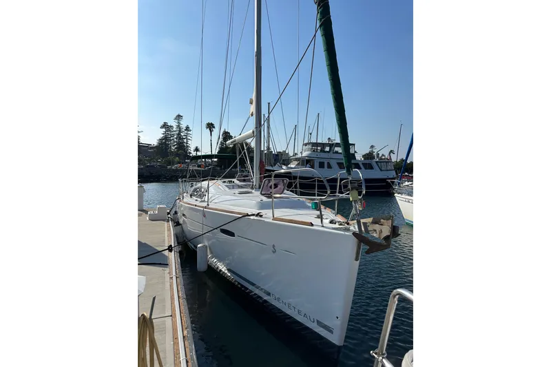 Shamrock Yacht Photos Pics 2011 Beneteau Oceanis 40 sailboat docked in a sunny marina.