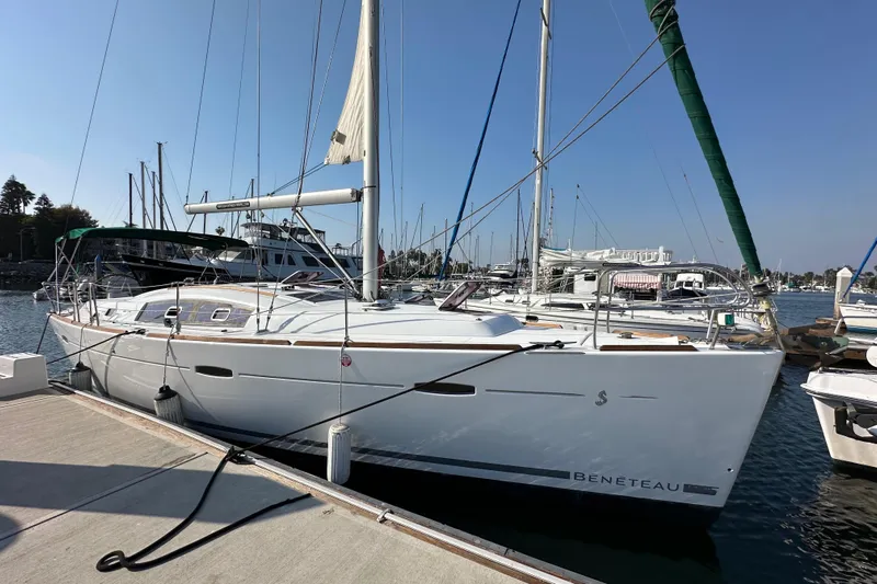 Shamrock Yacht Photos Pics 2011 Beneteau Oceanis 40 sailboat docked at marina under clear blue sky.