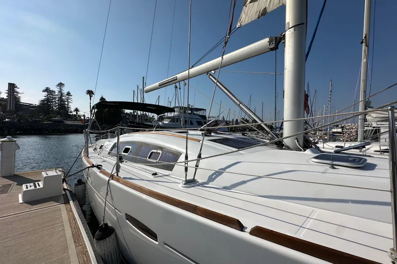 Shamrock Yacht Photos Pics 2011 Beneteau Oceanis 40 sailboat docked at marina under clear blue sky.