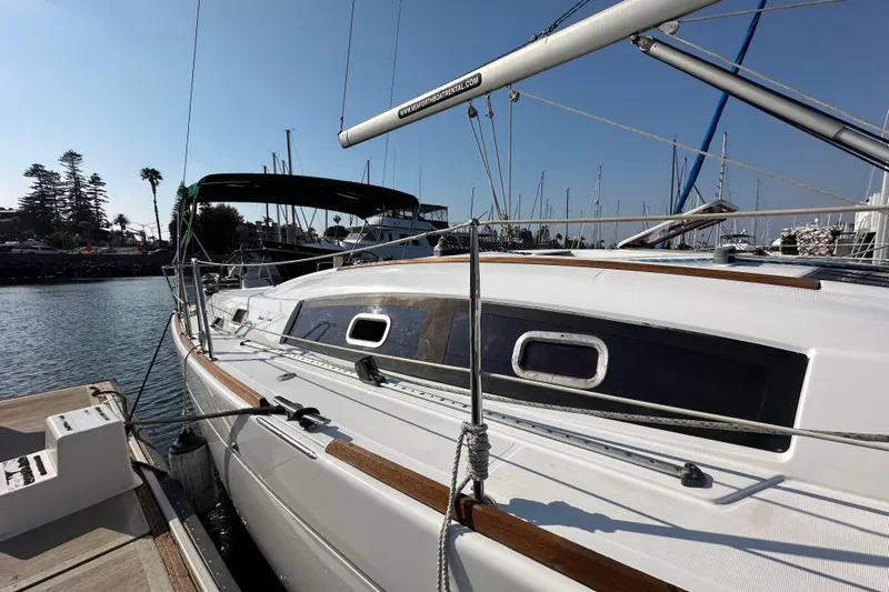 Shamrock Yacht Photos Pics 2011 Beneteau Oceanis 40 sailboat docked at marina under clear blue sky.