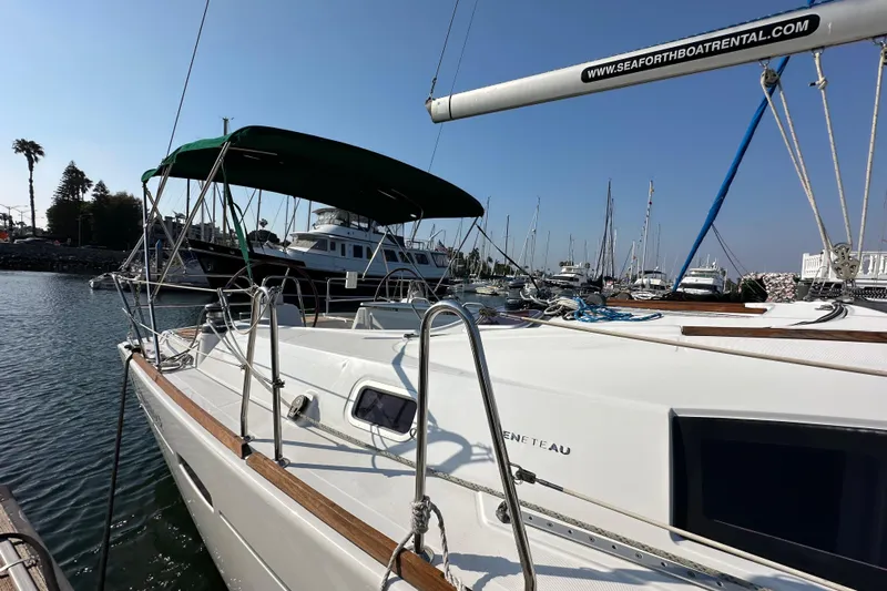 Shamrock Yacht Photos Pics 2011 Beneteau Oceanis 40 sailboat docked at marina, sunny day, green canopy.