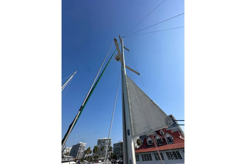 Shamrock Yacht Photos Pics Beneteau Oceanis 40 sailboat mast and sail against clear blue sky, 2011 model.