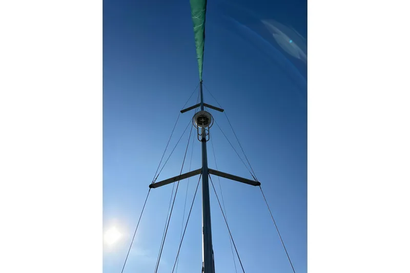 Shamrock Yacht Photos Pics Mast of 2011 Beneteau Oceanis 40 sailboat against clear blue sky.