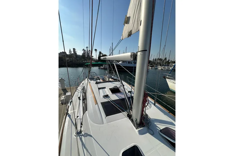 Shamrock Yacht Photos Pics 2011 Beneteau Oceanis 40 sailboat docked in a marina, showcasing its deck and mast.