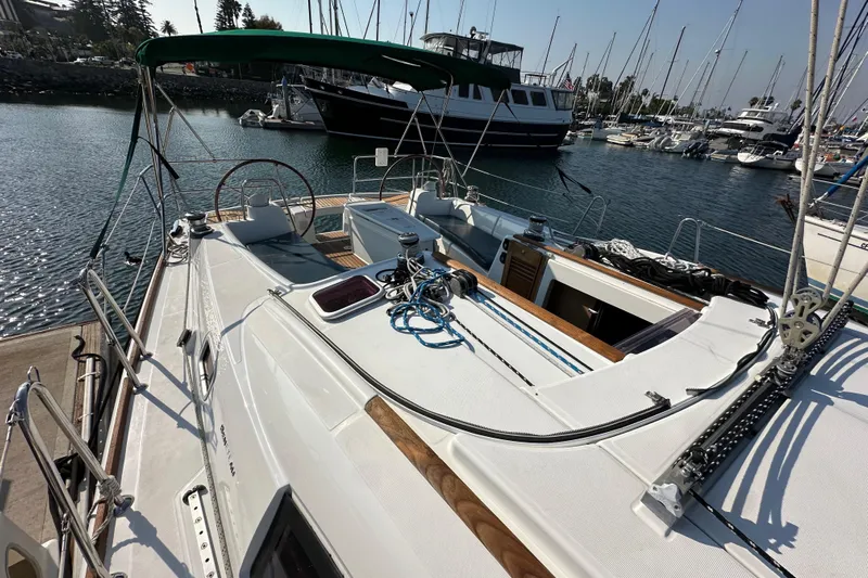 Shamrock Yacht Photos Pics Beneteau Oceanis 40 sailboat, 2011 model, docked in a marina with clear skies.
