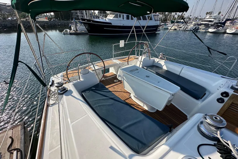 Shamrock Yacht Photos Pics 2011 Beneteau Oceanis 40 sailboat cockpit with dual steering wheels and cushioned seating.