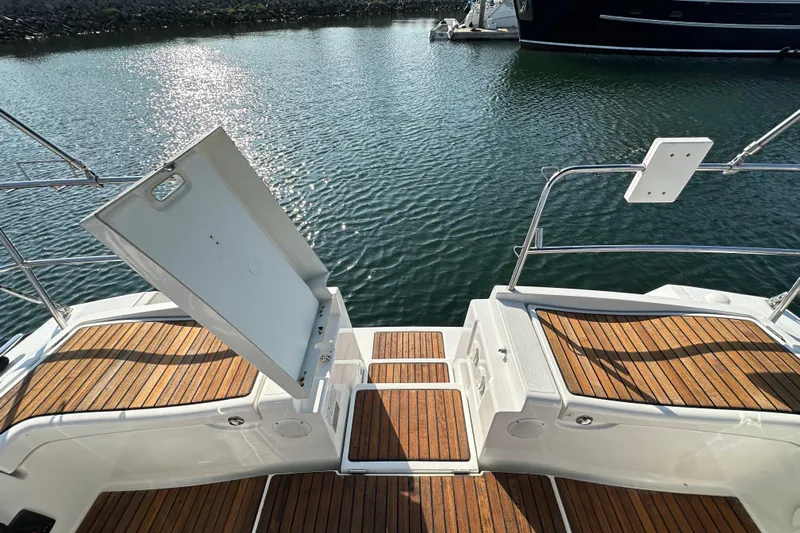 Shamrock Yacht Photos Pics Beneteau Oceanis 40 yacht deck with open hatch, 2011 model, on calm water.