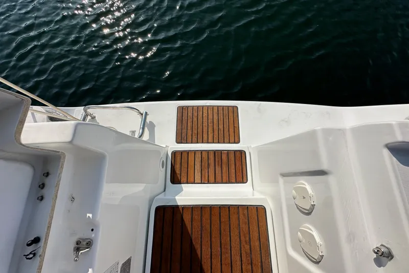Shamrock Yacht Photos Pics Beneteau Oceanis 40 yacht deck with wooden panels, 2011 model, overlooking water.