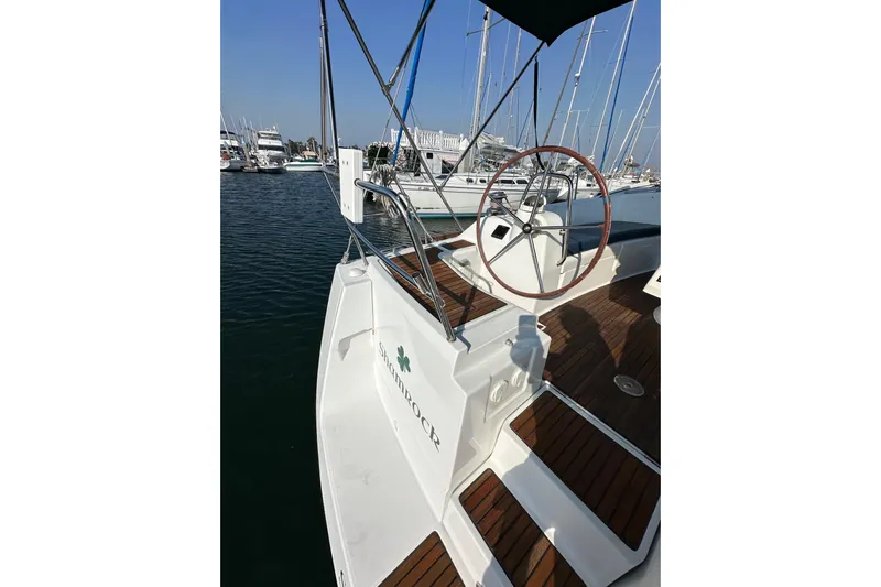 Shamrock Yacht Photos Pics 2011 Beneteau Oceanis 40 sailboat with wooden deck and steering wheel in marina.