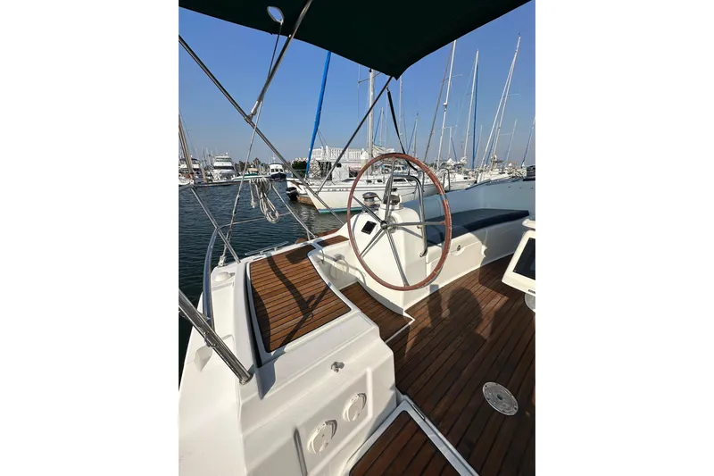 Shamrock Yacht Photos Pics Cockpit of 2011 Beneteau Oceanis 40 sailboat with wooden deck and steering wheel.