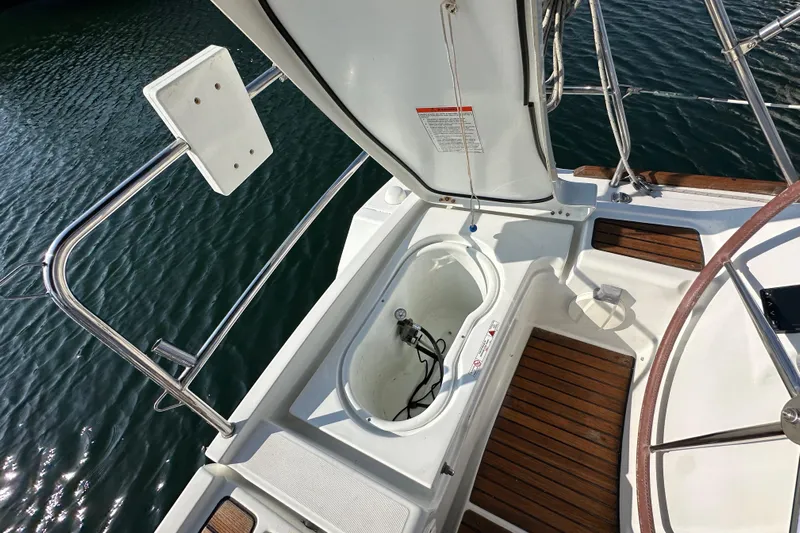 Shamrock Yacht Photos Pics 2011 Beneteau Oceanis 40 yacht deck with open storage compartment and wooden flooring.