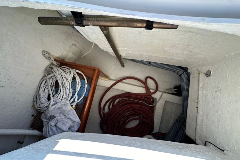 Shamrock Yacht Photos Pics Storage compartment on a 2011 Beneteau Oceanis 40 sailboat with ropes and hoses.