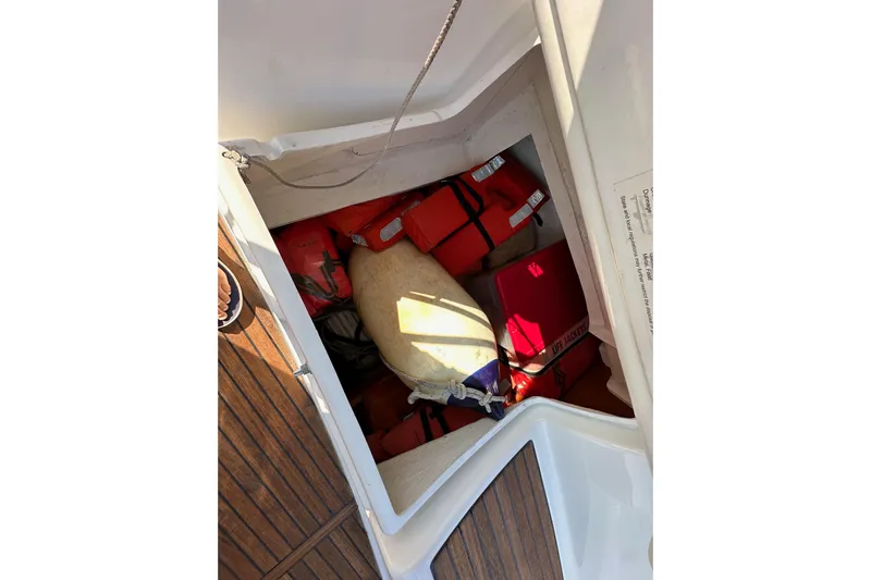 Shamrock Yacht Photos Pics Storage compartment on 2011 Beneteau Oceanis 40 with life jackets and safety equipment.