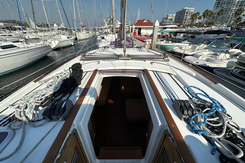 Shamrock Yacht Photos Pics Beneteau Oceanis 40 sailboat deck view, 2011 model, docked in a marina with surrounding boats.