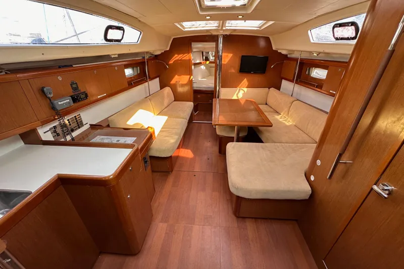 Shamrock Yacht Photos Pics Interior of 2011 Beneteau Oceanis 40 sailboat with wood finish and cozy seating area.