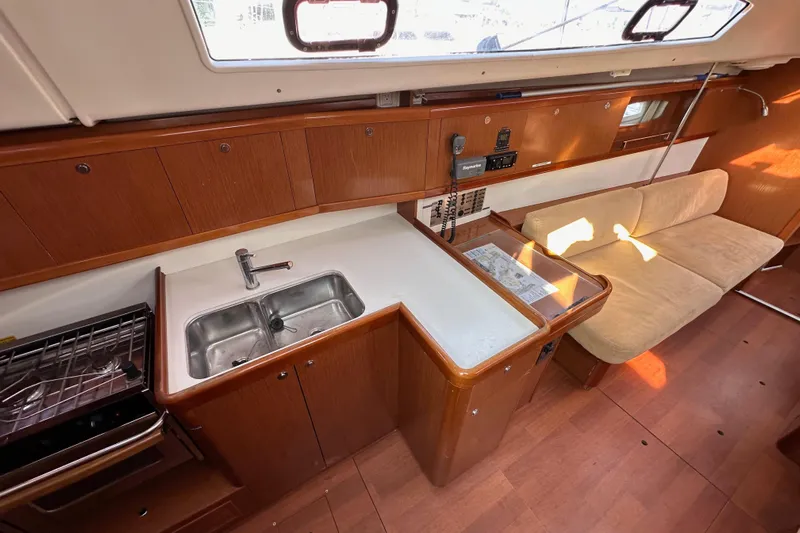 Shamrock Yacht Photos Pics Interior of 2011 Beneteau Oceanis 40 yacht with kitchen and seating area.