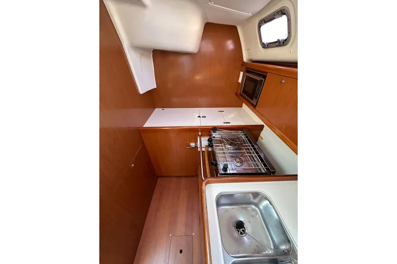 Shamrock Yacht Photos Pics Interior view of 2011 Beneteau Oceanis 40 yacht kitchen with stove and sink.