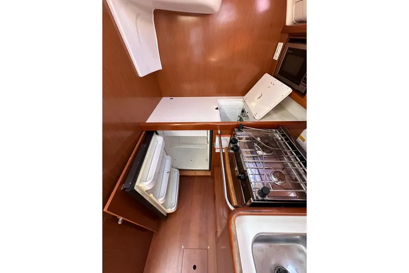 Shamrock Yacht Photos Pics Interior of 2011 Beneteau Oceanis 40 yacht kitchen with stove, sink, and fridge.