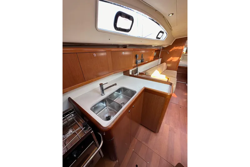 Shamrock Yacht Photos Pics Interior of 2011 Beneteau Oceanis 40 yacht, featuring a modern kitchen and seating area.