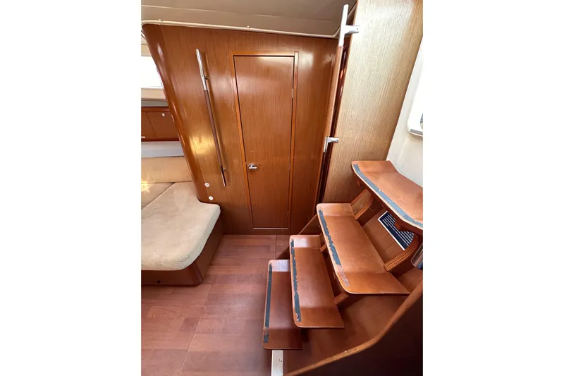 Shamrock Yacht Photos Pics Interior of 2011 Beneteau Oceanis 40 yacht with wooden stairs and seating area.