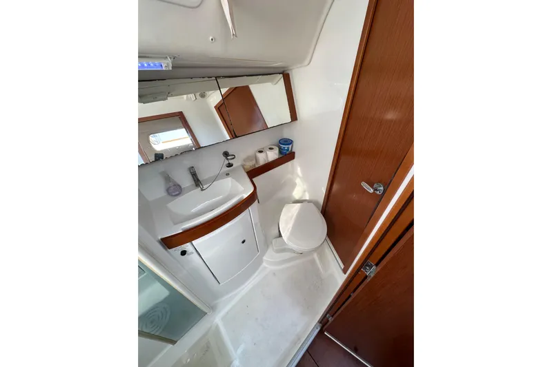Shamrock Yacht Photos Pics Bathroom interior of 2011 Beneteau Oceanis 40 yacht, featuring sink, toilet, and mirror.