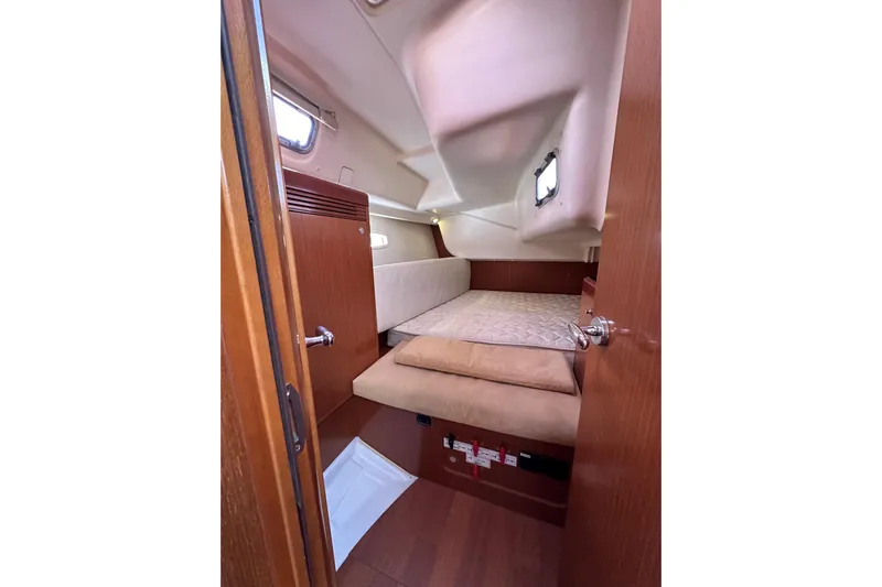 Shamrock Yacht Photos Pics Cozy cabin interior of 2011 Beneteau Oceanis 40 sailboat with wooden finish.