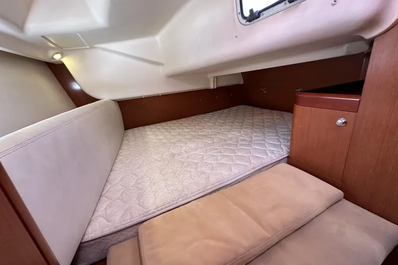 Shamrock Yacht Photos Pics Cozy cabin interior of 2011 Beneteau Oceanis 40 sailboat with comfortable bedding.