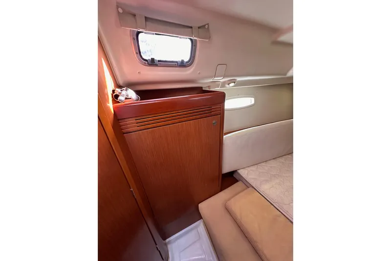 Shamrock Yacht Photos Pics Interior cabin of 2011 Beneteau Oceanis 40 yacht, featuring wood paneling and a window.