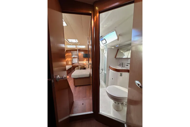 Shamrock Yacht Photos Pics Interior view of 2011 Beneteau Oceanis 40 yacht, featuring a cozy cabin and bathroom.