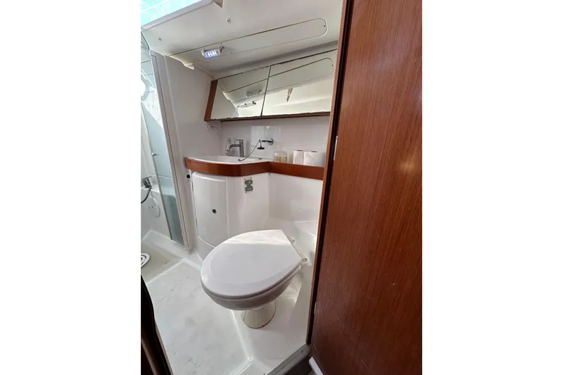Shamrock Yacht Photos Pics Bathroom interior of 2011 Beneteau Oceanis 40 yacht, featuring modern fixtures and wood accents.