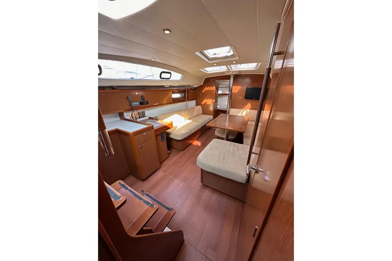 Shamrock Yacht Photos Pics Interior of 2011 Beneteau Oceanis 40 yacht, featuring cozy seating and wooden finishes.