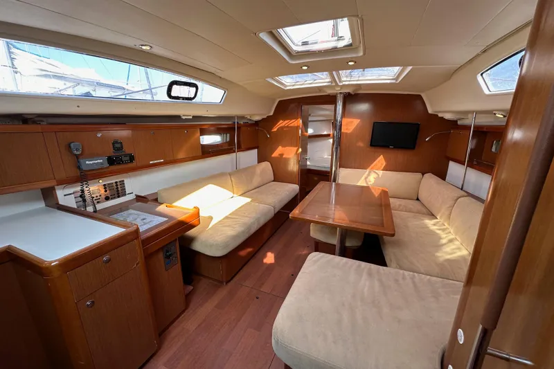 Shamrock Yacht Photos Pics Interior of 2011 Beneteau Oceanis 40 yacht with cozy seating and wooden finishes.